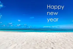 Happy new year written in the sky. Artistic summer beach holiday with new years eve concept