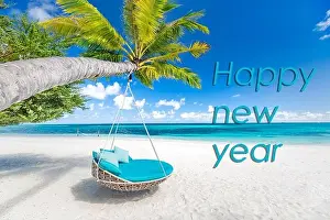 Happy new year written in the sky. Artistic summer beach holiday with new years eve concept
