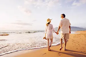 Gray Hair Prints: Happy Romantic Middle Aged Couple Enjoying Beautiful Sunset Walk on the Beach