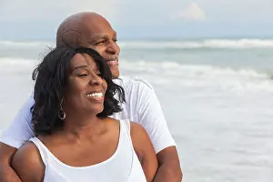 Senior Man Prints: Happy romantic senior African American man and woman couple on a deserted tropical beach