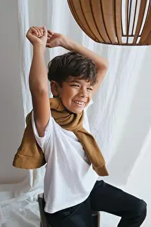 Curtains Prints: Happy squinting indian asian kid looking at the camera, stretching