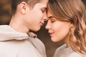 Flirt Prints: Happy teen boy and girl 16-18 year old posing together with closed eyes closeup