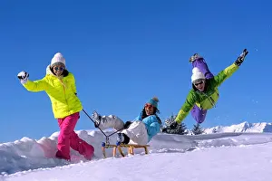 Jolly Prints: three happy teens playing in snow, France, Savoie, Val d Isere