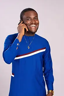 Satisfied Prints: happy young african man smiling while making a phone call