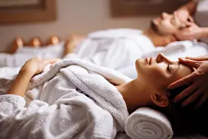 Therapist Prints: happy young beautiful couple enjoying head massage at the spa