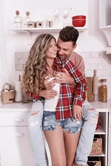happy young couple in love are hugging and having fun in the kitchen on Valentine's day in the morning