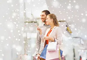 Satisfied Prints: happy young couple with shopping bags in mall