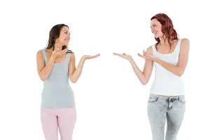 Redhead Prints: Two happy young female friends holding out their hands