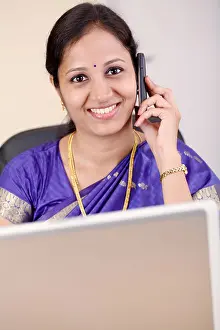 Sari Prints: Happy young Indian tradtional business woman talking on cellphone