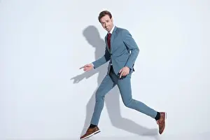 Full Body Prints: happy young man in blue suit jumping in the air