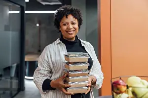 25 30 Years Prints: Happy young woman with take away food boxes standing in office