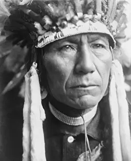 American Indian Prints: Head-and-shoulders portrait of a Nez Percé man in full feather headdress