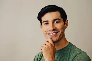 Casual Attire Prints: Headshot smiling handsome young adult latino man with hand on chin black hair