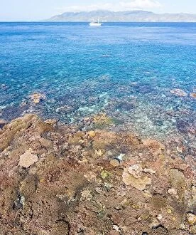 Aerial Landscape Collection: Healthy coral reefs surround a remote island in Indonesia's Banda Sea
