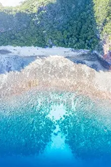 Healthy coral reefs surround a remote island in Indonesia's Banda Sea. This remote, tropical region harbors extraordinary marine biodiversity