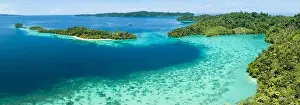 Karas Prints: Healthy fringing coral reefs grow around the beautiful islands that rise from West Papua's seascape