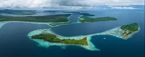A healthy, robust coral reef surrounds a scenic bay in the Solomon Islands. This beautiful country is home to spectacular marine biodiversity