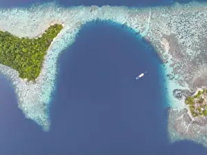 A healthy, robust coral reef surrounds a scenic bay in the Solomon Islands. This beautiful country is home to spectacular marine biodiversity