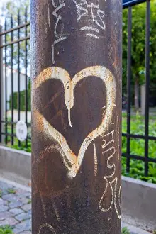 Vandalism Prints: Heart-shaped graffiti on a lamppost