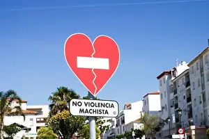 Heart-shaped traffic sign No Violencia Machista installed in an awareness campaign against domestic violence in Manilva - Malaga province, Spain