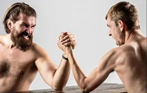Handshake Prints: Heavily muscled bearded man arm wrestling a puny weak man