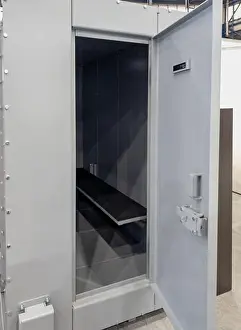 Steel Construction Prints: A heavy-duty modular steel safety cabin and armored capsule featuring an open door and a simple bench inside