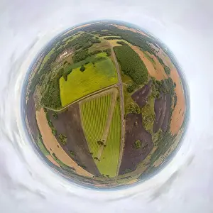Helicopter drone shot. Aerial photography of a green field, roan and forest. Panoramic city 360 shot from above
