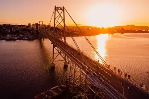 Hercilio luz old cable bridge with golden sunset sky in Florianopolis. Drone view