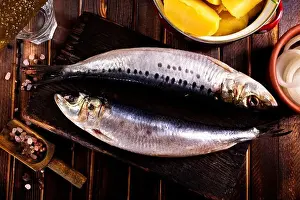 Salted Prints: Herring or Baltic herring with salt on dark backgruond