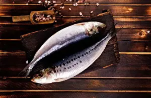 Salted Prints: Herring or Baltic herring with salt on dark backgruond