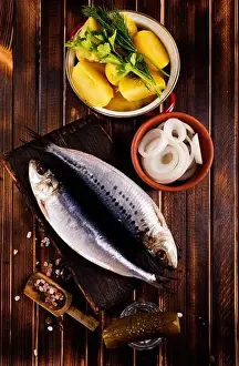 Herring or Baltic herring with salt on dark backgruond