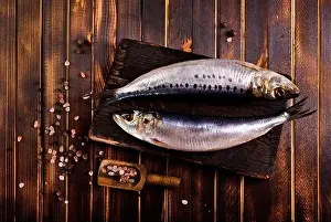 Salted Prints: Herring or Baltic herring with salt on dark backgruond