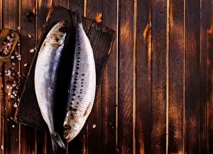 Salted Prints: Herring or Baltic herring with salt on dark backgruond