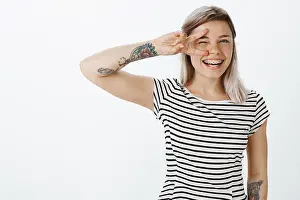Glad Prints: Hey sailor. Portrait of charming playful young girl with fair hair and tattoos on arms