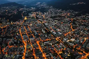 Aerial Cityscape Prints: High angle aerial drone night shot of city street lights in Lugano, Switzerland