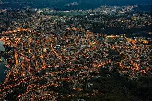 Aerial Cityscape Prints: High angle aerial drone shot view Lugano by lake with city street lights after sunset in Switzerland