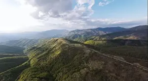 Balkan Mountains Prints: High angle aerial view drone image of sunset sun rays trough the trees