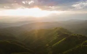 Balkan Mountains Prints: High angle aerial view drone image of sunset sun rays trough the trees