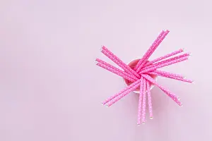 Paper Cup Prints: High angle view of paper cup with rose drinking straws polka design on pastel pink background minimal creative concept