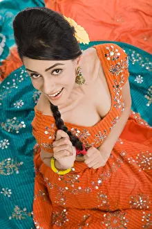 Braids Prints: High angle view of a woman posing in lehenga choli