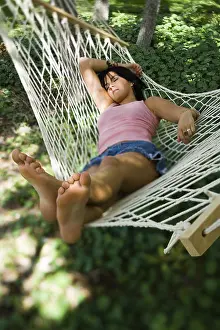 Ankle Prints: High angle view of a young woman sleeping in a hammock