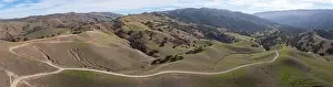 High clouds and blue skies form a canopy over the serene hills of Livermore, California. This region turns from brown to green during winter months