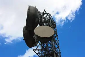 Communication Network Prints: high large antennas transmitting signals with current satellite dishes and high intensity electrical cables