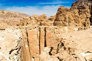 White Clouds Prints: high rocky mountains against the blue sky and white clouds in the desert in Egypt Dahab South Sinai