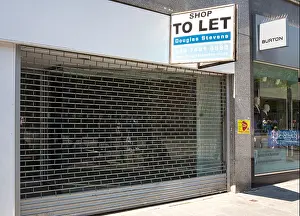 Shutters Prints: Empty High Street shop to let on Exeter High Street, Exeter, Devon, England