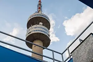 The high tourist observation tower Snezhana on the mountain peak of Snezhana covered with evergreen spruce dense