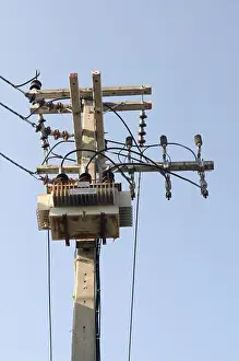 Breaker Prints: High voltage electric transformer in a power substation above the tower