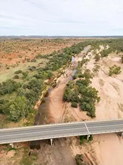 Roadtrip Prints: Highway passes over an almost dry river bed in remote Northern Territory