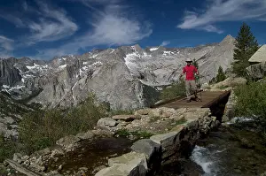 High Country Prints: Hiker crossing a bridge above Le Conte Canyon in Kings Canyon National Park California