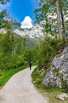 Chill Prints: Hiker films with the small camera on the forest path around the Hintersee